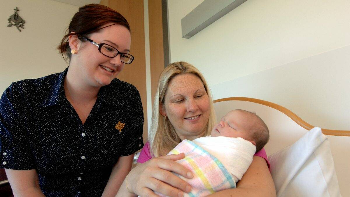 WELCOME: St John of God Hospital midwife Kate Zakynthios with Nerissa Walter and her new daughter Alexis. PICTURE: JEREMY BANNISTER