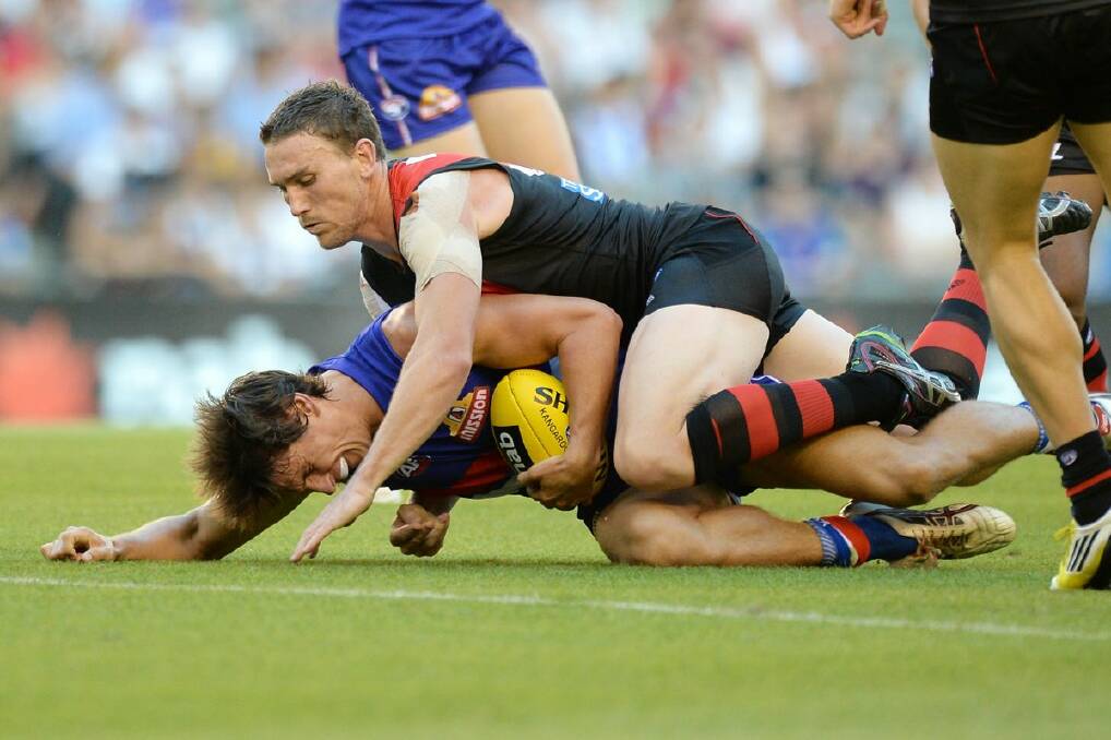  Ryan Griffen of the Bulldogs is tackled by Heath Hocking during the round one AFL NAB Cup match last night. 