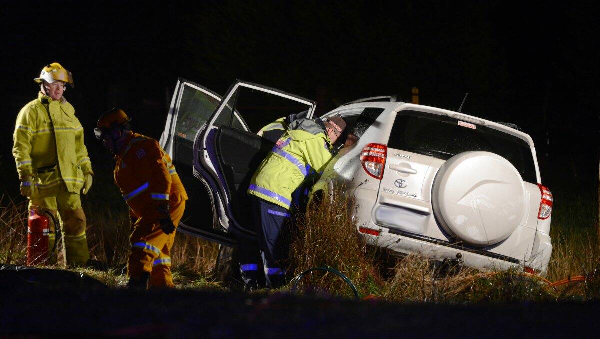 Emergency workers at the scene of a fatal accident at Mt Rowan on Saturday night.