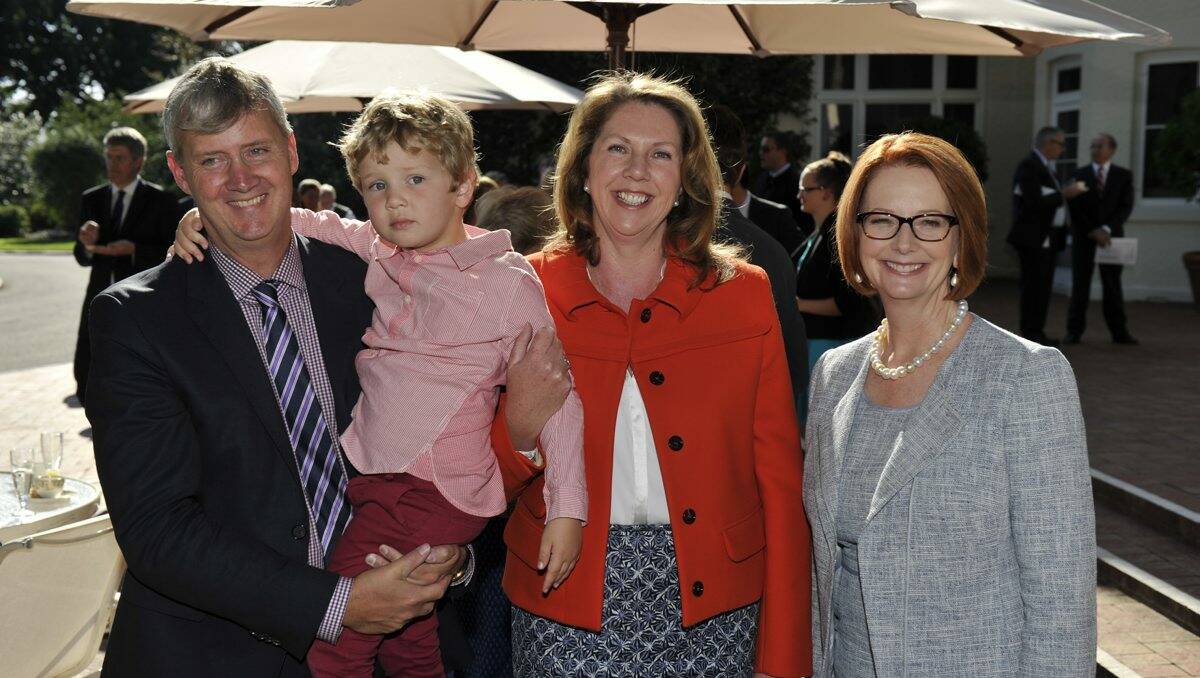 Catherine King is all smiles yesterday as she stands with Prime Minister Julia Gillard, her husband Mark Karlovic and son Ryan Karlovic after being promoted to the frontbench in a reshuffle.