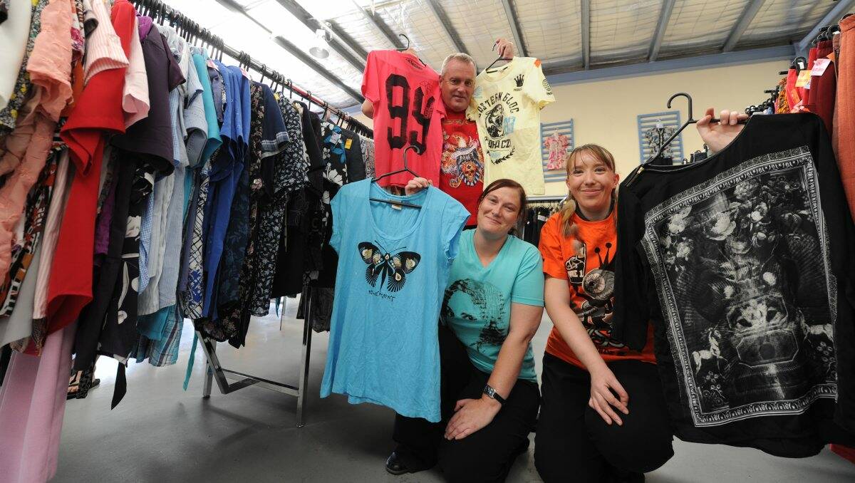 PRE-LOVED: Peter Harris, Kelly Juniper and Kylie Broughton check out some of the secondhand T-shirts for sale. PICTURE: JUSTIN WHITELOCK