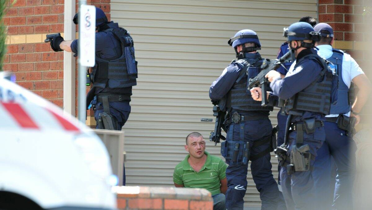 Police surround Scott Pearce, 25, at the end of the five-hour siege in March.