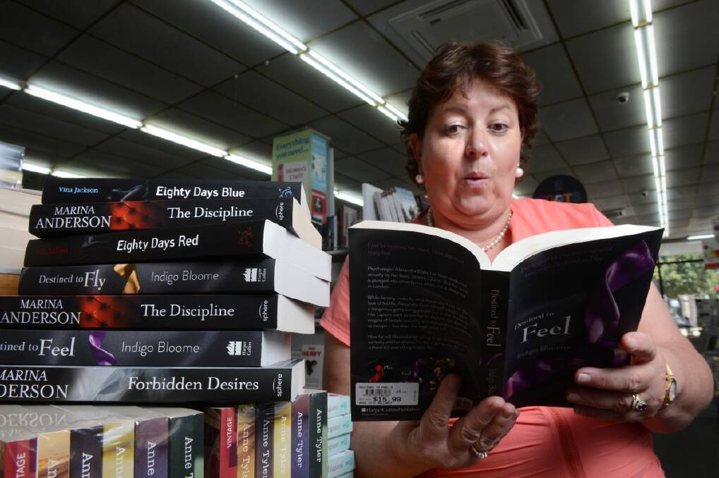  Tracey Willersdorf, buyer for Collins Booksellers Ballarat, takes a peak at one of the erotic novels, which are growing in popularity. 