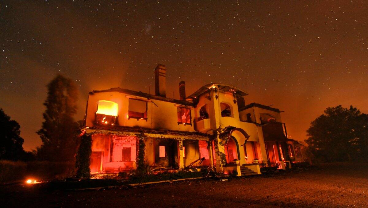 The historic Carngham Station homestead still burning under the night sky last night after copping the full brunt of the Chepstowe blaze. PICTURE: JUSTIN MCMANUS