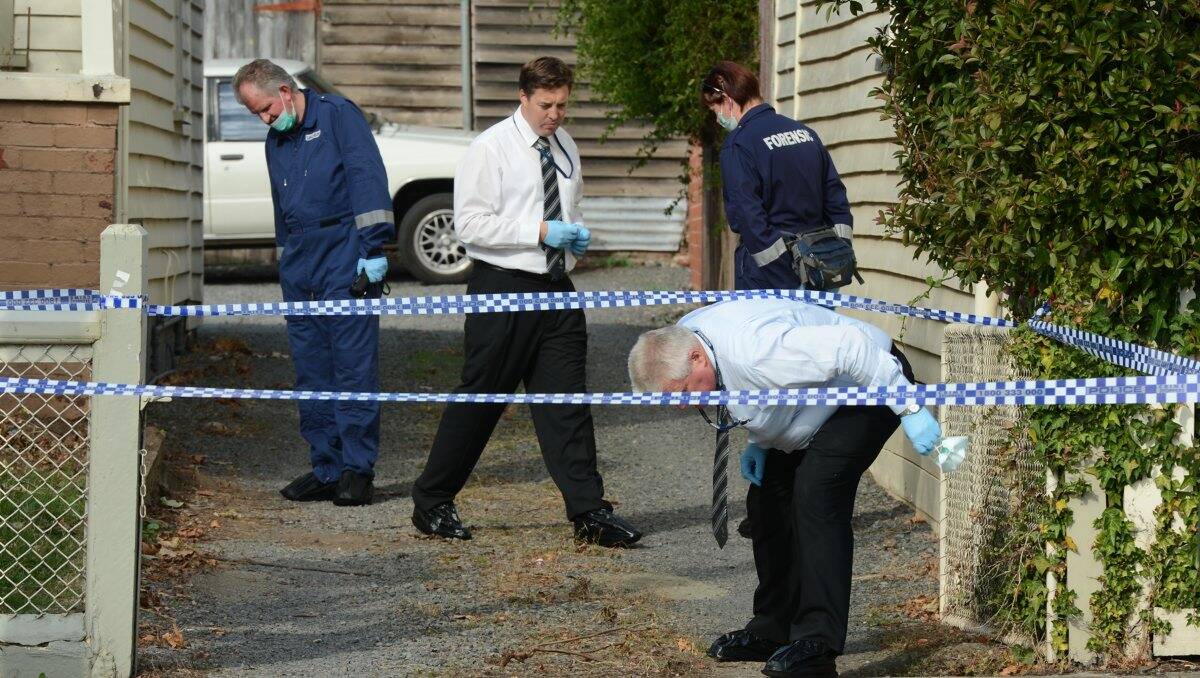 Police investigate the crime scene at a Doveton Street home.