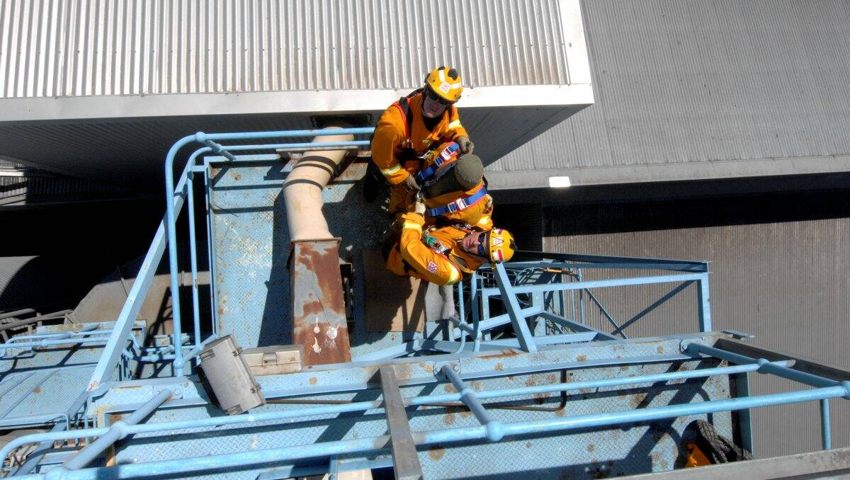 Leading Firefighter Jarrod Howlett and firefighter Darryl Longhurst with Fred the dummy during a rescue exercise at Joe White Malting in Delacombe yesterday.
