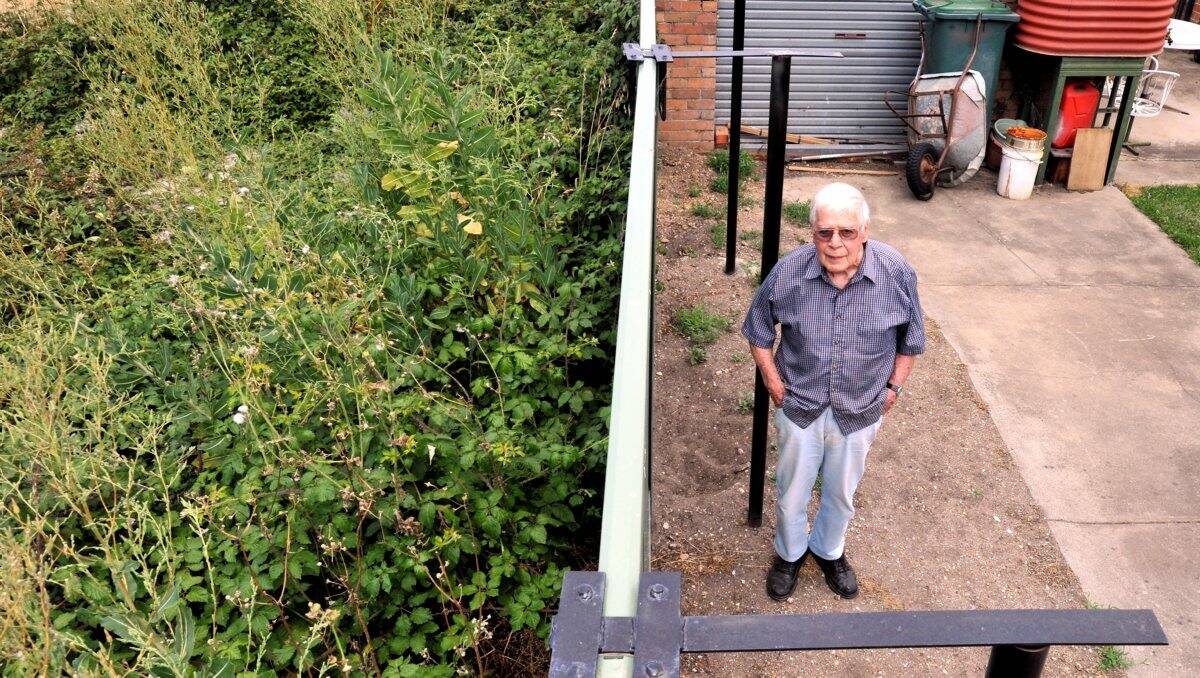  Les Deane is worried about the weeds on the next-door property.