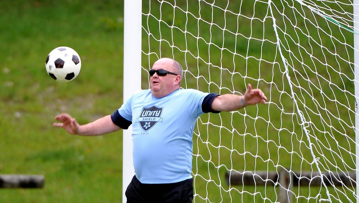SHIELD: Police officer Des Hudson taking part in the Unity Shield soccer match yesterday. PICTURE: LACHLAN BENCE