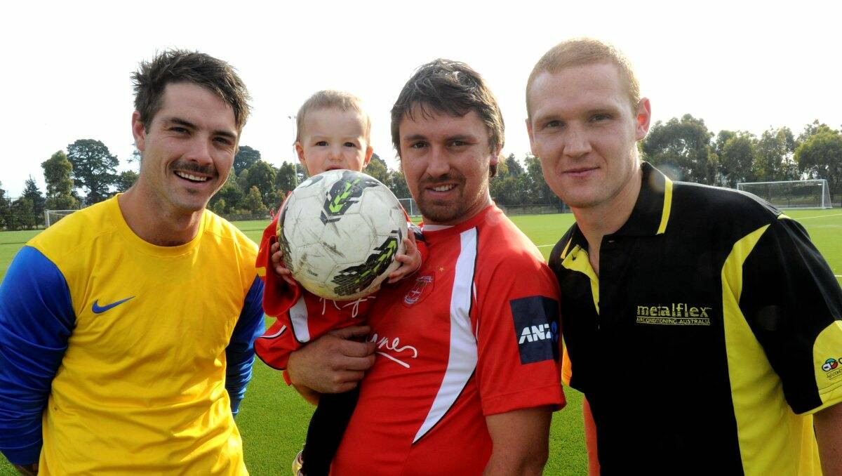 Summer soccer: Paul McClounan, Josh Romein with daughter Leni, and Shaun Romein are among those keeping fit and raising money for charity over the warmer months by participating in Ballarat’s Summer Sevens soccer competition. PICTURE: JEREMY BANNISTER