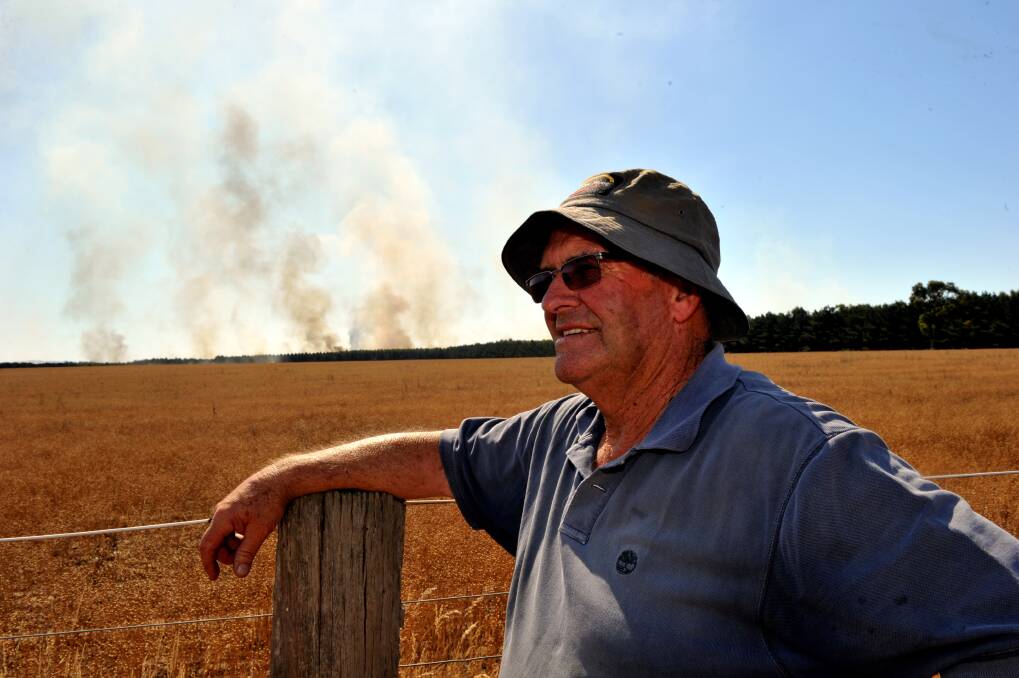 Gordon Powell watches the fire near his son's property