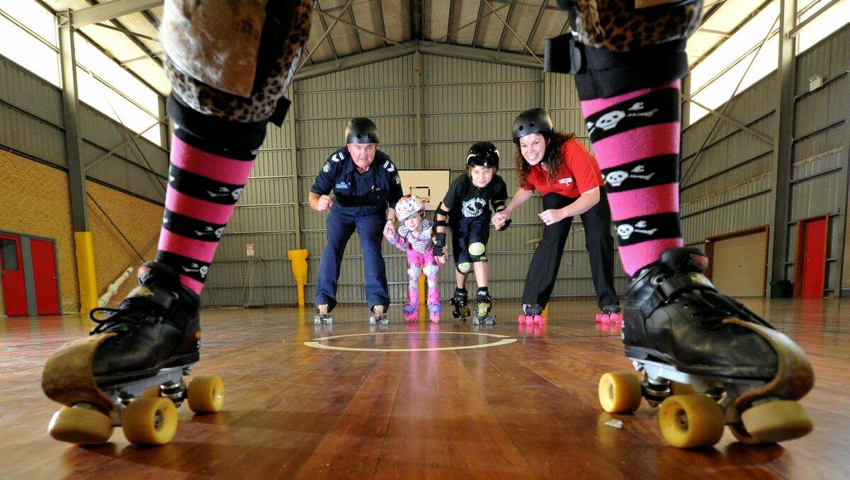 Disco: Leading Senior Constable Des Hudson of the Blue Light Disco and Rebekah Turner from the YMCA with young skaters Aiden Bell and Olivia Fry. PICTURE: JEREMY BANNISTER