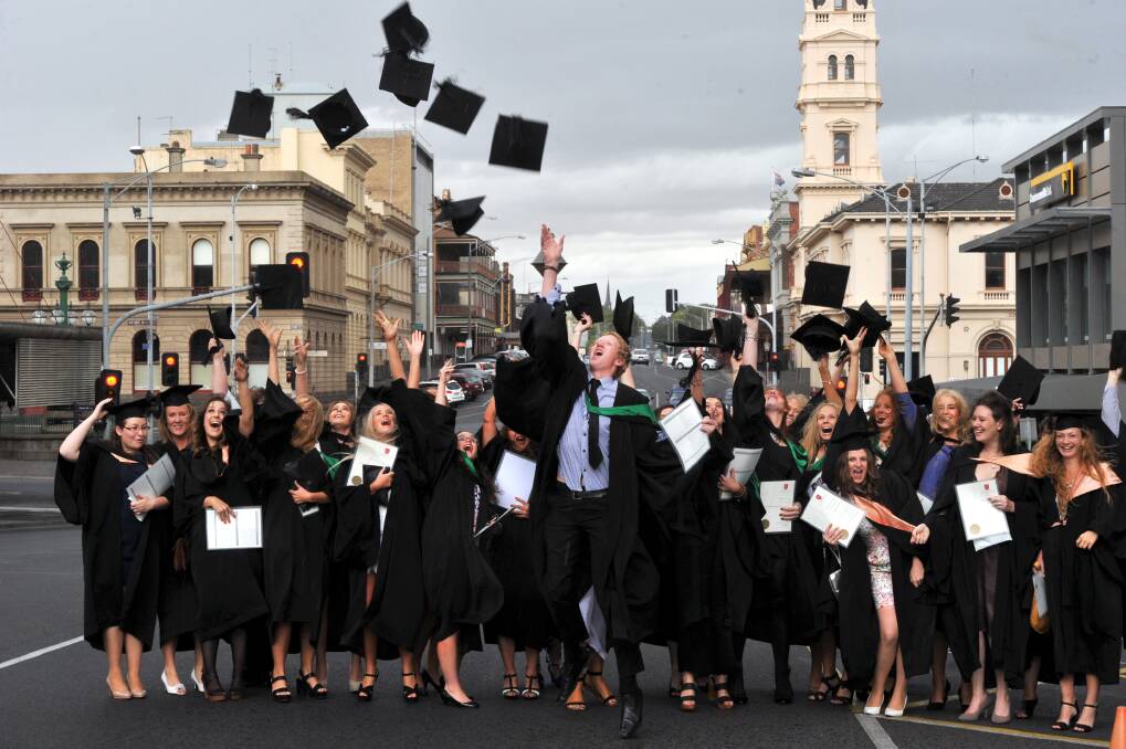  ACU students celebrate their graduation outside Her Majesty’s Theatre in Lydiard Street.