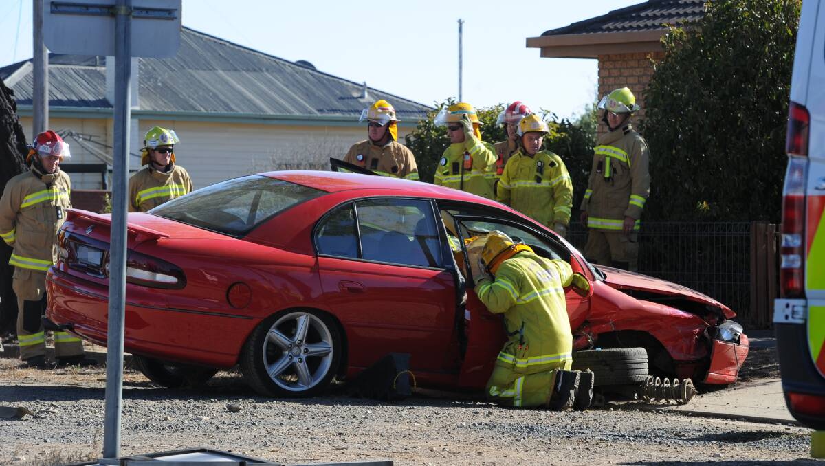 Fire crews help to free a trapped man after a crash at the corner of Albert and Wall streets in Sebastopol yesterday.