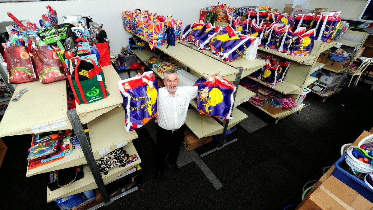 HELPING HAND: Geoff Ryan with some of the hundreds of hampers and gifts ready for needy families. PICTURE: JEREMY BANNISTER