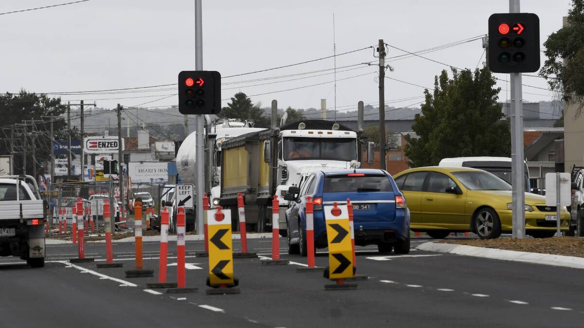 Vehicles at the newly activated La Trobe Street and Wiltshire Lane traffic lights. Picture by Lachlan Bence