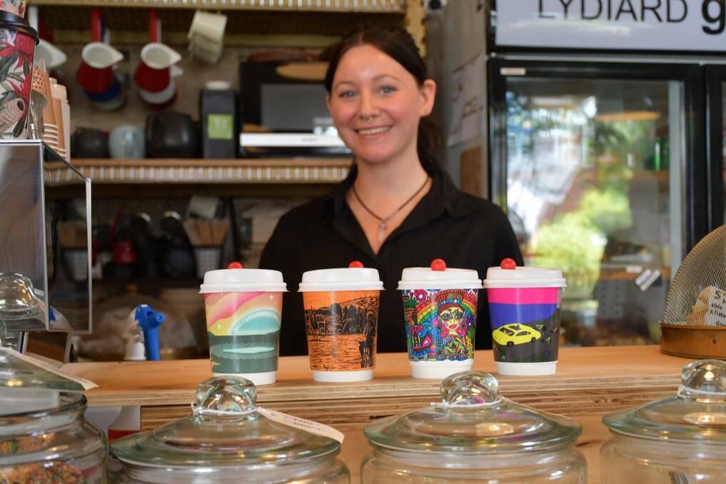 The four special coffee cups designed by local Ballarat artists for RoadNats 2024 with LYDIARDgeneral's Linda Fleming. Picture by Alex Dalziel