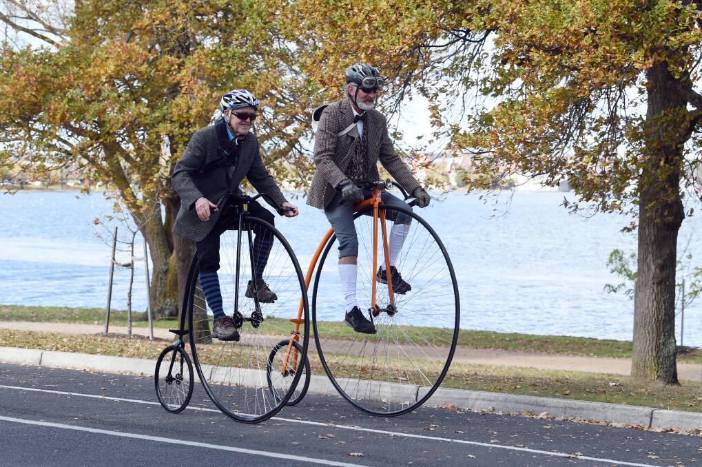 ON YOUR BIKE: Two cyclists riding around Lake Wendouree as part of the Heritage Festival's Tweed Ride event.