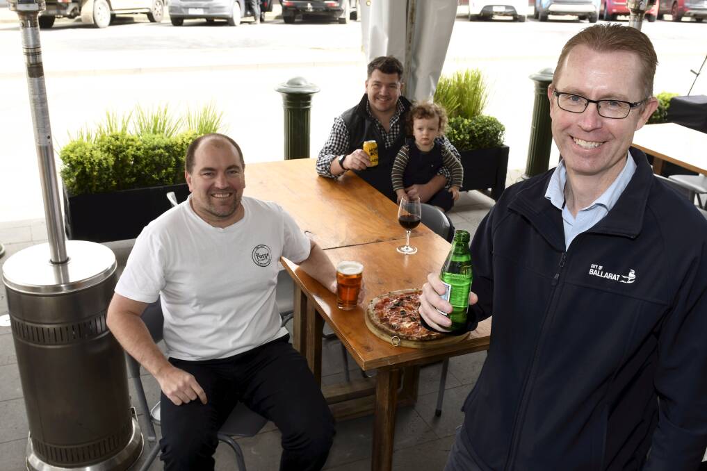 READY TO OPEN: City of Ballarat chief executive Evan King with The Forge Pizzeria owner Tim Matthews, Chris Matthews and Paddy. Picture: Lachlan Bence