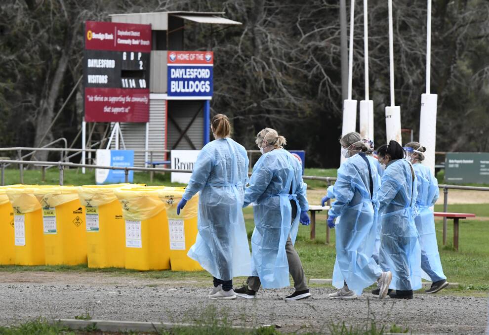 INTO BATTLE: Health workers start their shift as pop-up testing starts in Daylesford on Saturday after one case and three exposure sites were confirmed. Picture: Lachlan Bence