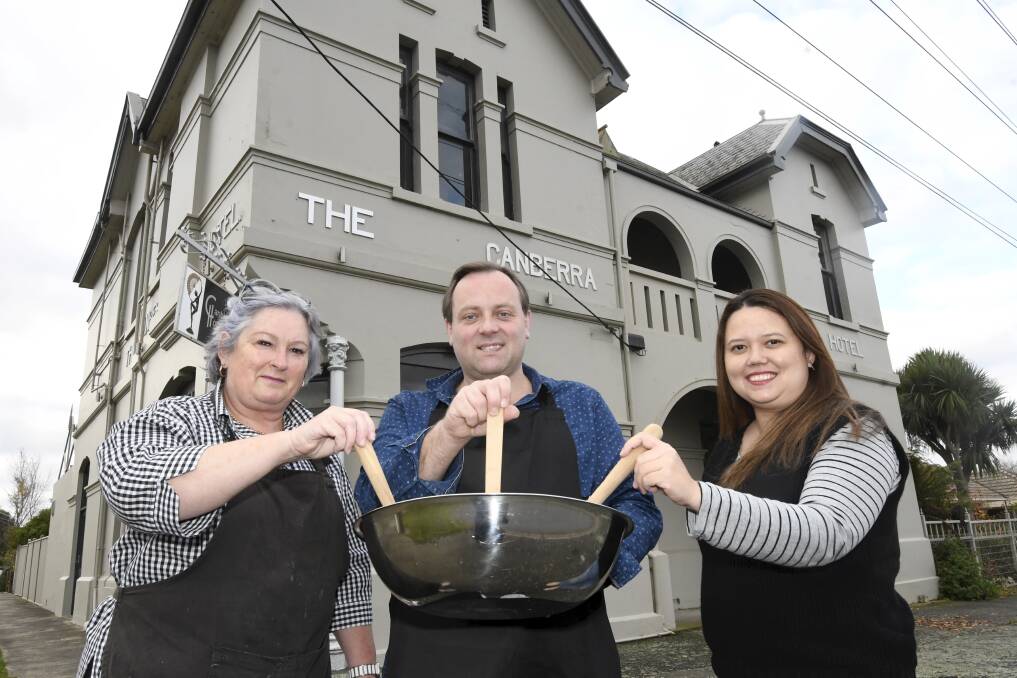 GIVING: Alfredton Rotary Club members Jill Oliver and Malcolm Roberts and Young Ambition president Jane Jens are helping those in need with free meals on Friday night. Picture: Lachlan Bence