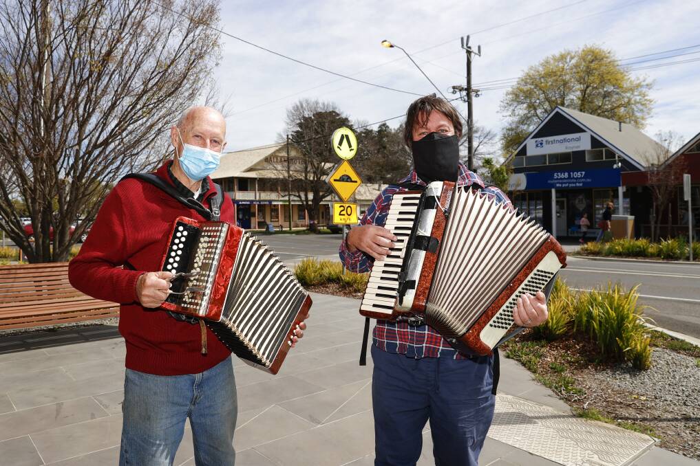 BACK AT IT: Ballan buskers Greg Herd and Leon Conway perform on Inglis Street after the Moorabool Shire lockdown was lifted. Picture: Luke Hemer