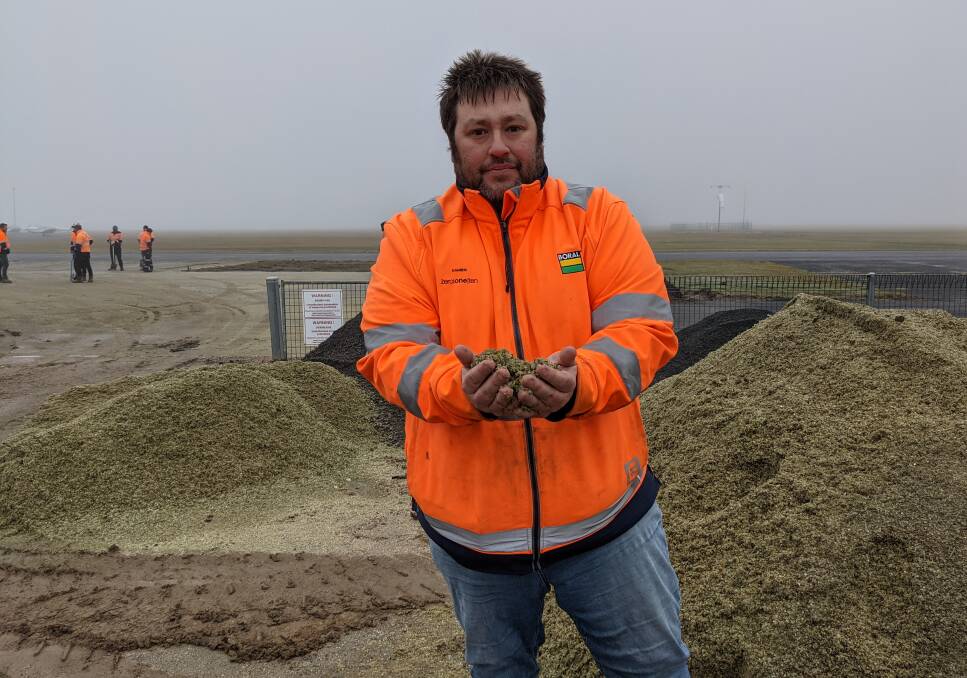 REUSED: Boral project manager Damien Hayes with the recycled glass material that could be used in Ballarat roads in the future.