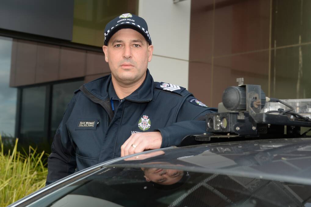 LOOK OUT: Ballarat Highway Patrol acting senior sergeant David Whitwell with one of the cars fitted with automatic number plate recognition technology. Picture: Kate Healy