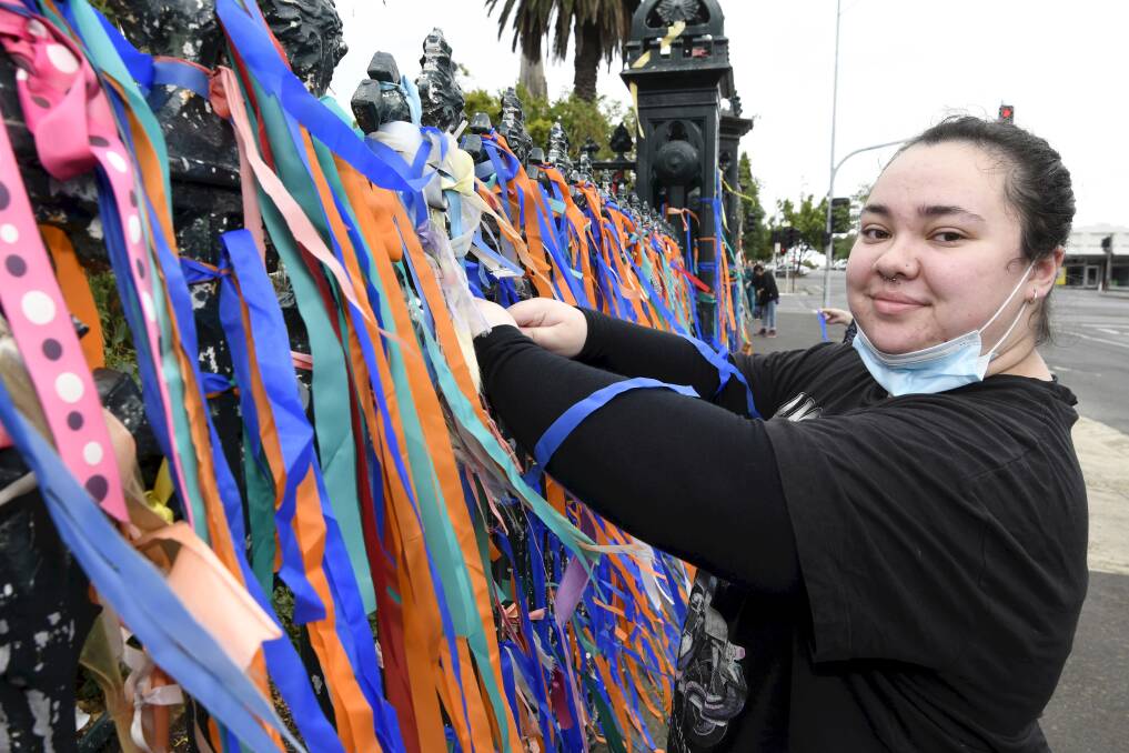 BRIGHT NOTE: Jaida Wilson is in awe of community support with hundreds of new ribbons on the St Patrick's Cathedral fence. Picture: Lachlan Bence