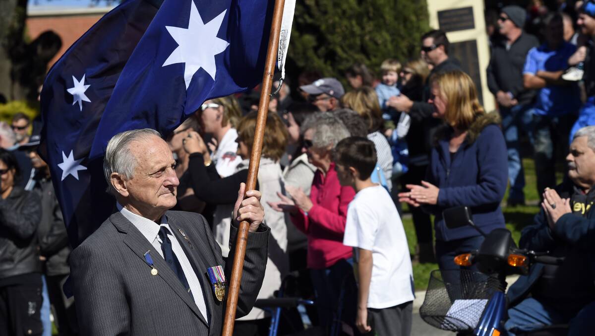 VALE: Vic Bradley carrying the flag at the Buninyong Anzac Day march in 2014.