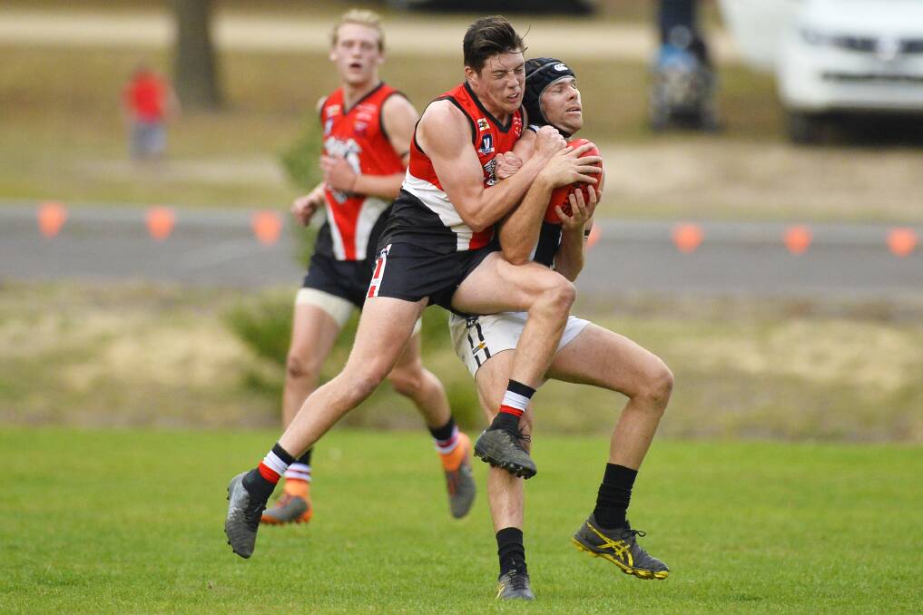 Dean O'Brien clashes with Lachlan Wrigley of Clunes. Picture: Dylan Burns