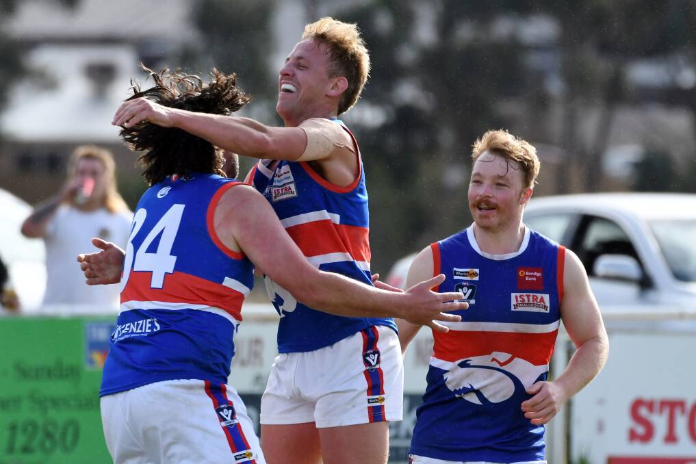 Daylesford players Jack Pitts, Christopher Peart and Emlyn Nettleton celebrate a goal in their first win of the season over Ballan. Picture: Kate Healy