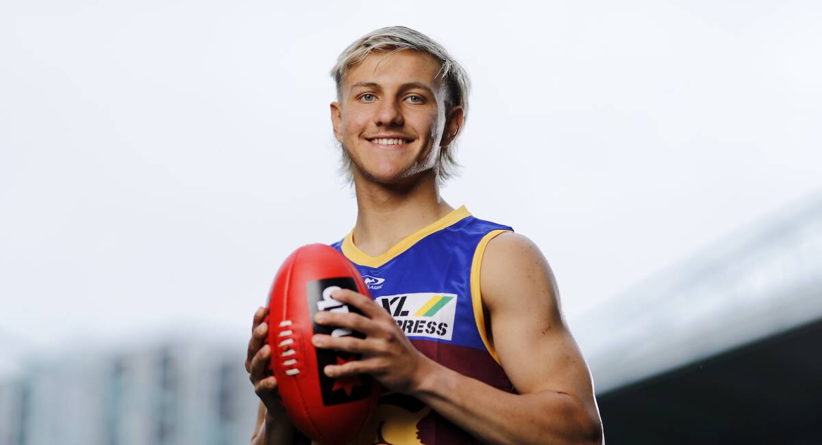Kai Lohmann quickly pulled on his new jumper at Marvel Stadium on Thursday. Picture: Dylan Burns/AFL Photos/Stringer
