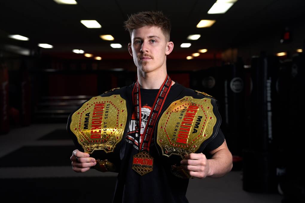 Harry Webb now holds two Demolition Fight Series amateur title belts following his most recent win. Picture: Adam Trafford