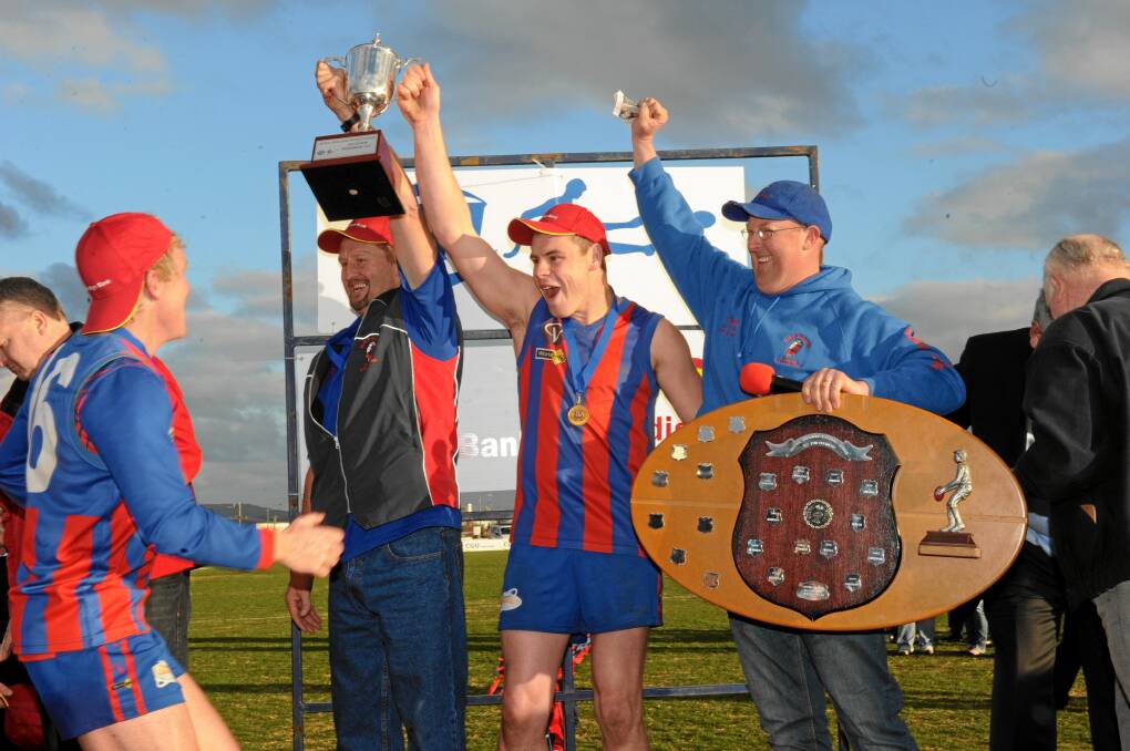 Shane Robertson and Jason Olver hold the 2010 premiership cup aloft with then captain Alan Ware. 