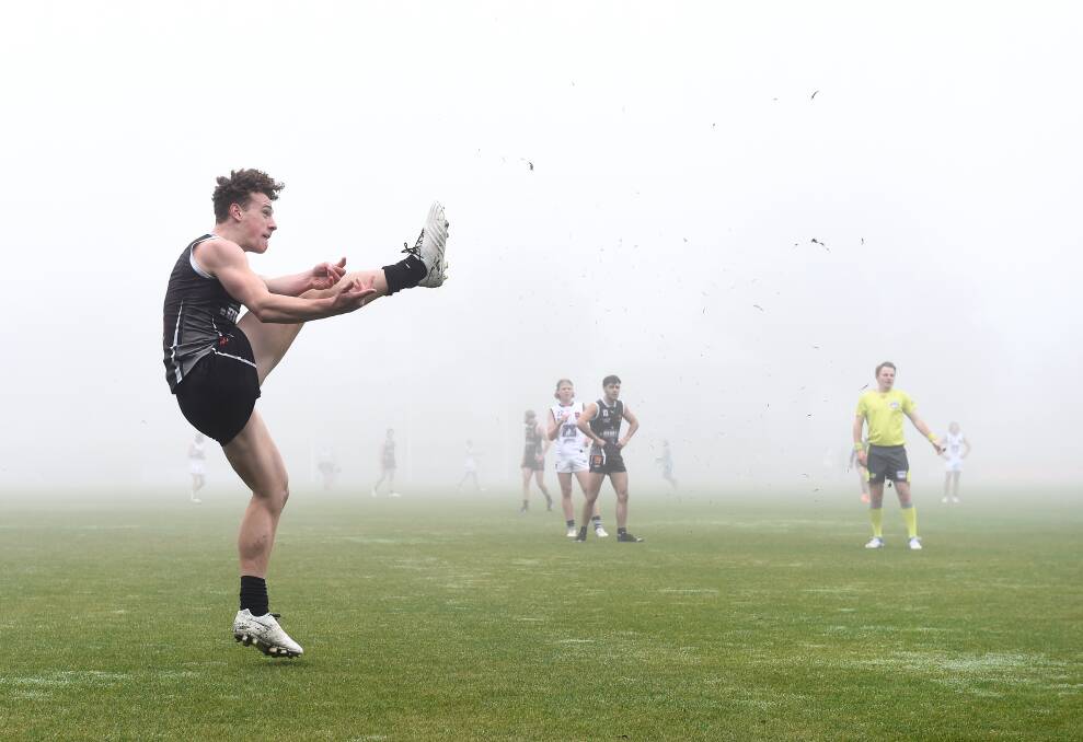 Joshua Rentsch kicks one of his game high three goals in the first quarter, when the fog was at its worst. Picture: Adam Trafford