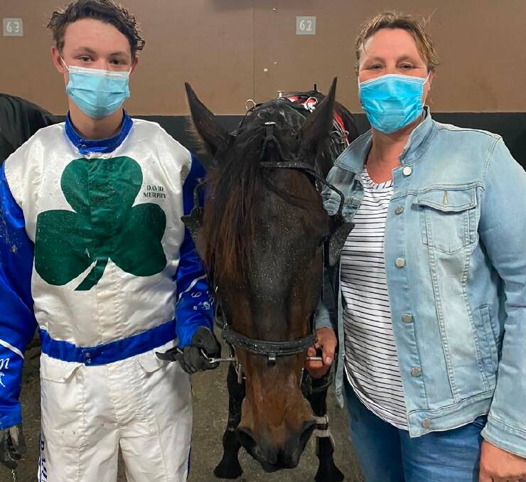 Declan was all smiles behind a mask post-race with Atego Shades and mother Erin. Picture: Ballarat and District Trotting Club Facebook