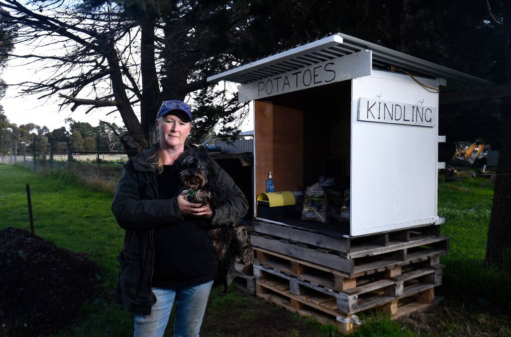Tough time:Georgia Kirby at the roadside stall where the honesty box was raided. Picture: Adam Trafford