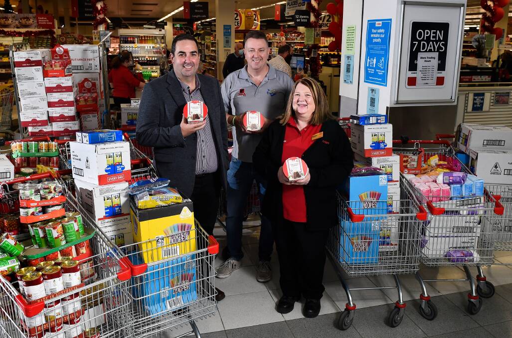 FIFTEEN TITANIC TROLLEYS: Michael Rice, John Fitzgibbon, and Sharon Germon with some of the goods to go to those in need. Picture: Adam Trafford.