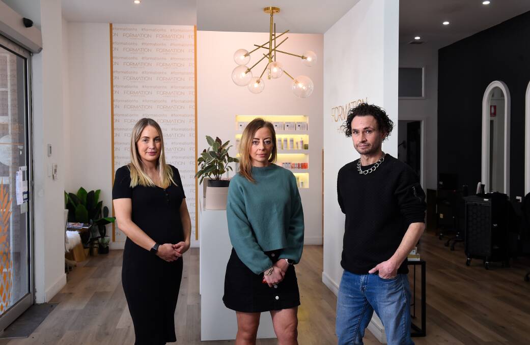 CUT DOWN: Owner Bec Reeves (middle) with staff, Jaid Brimacombe (left) and Adam Nowell, of Formation Hairstylists which will be empty from this weekend due to the changed government regulations. Picture: Adam Trafford.