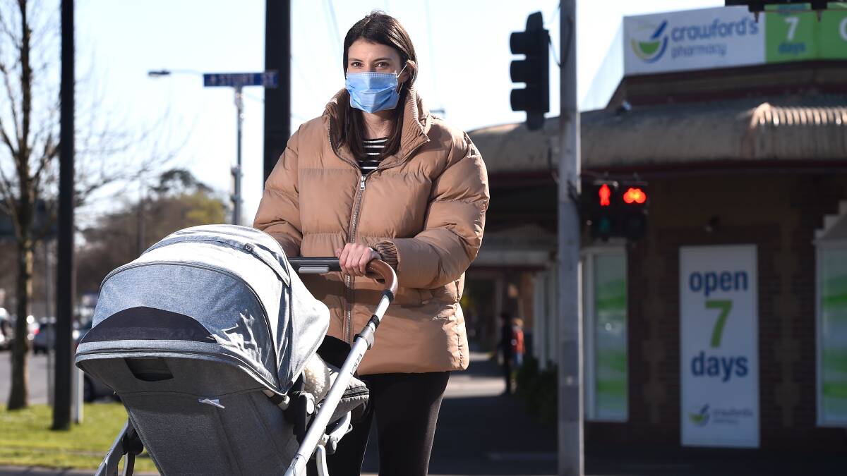 PEDESTRIANS UNDER PRESSURE: Young mother Philippa Thomas finds it hard to cross Sturt Street with son Archie in the pram.
