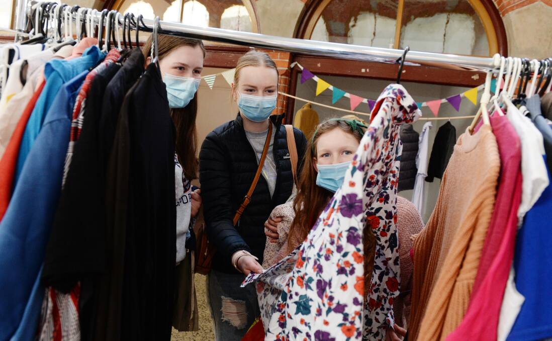CLOTHES SWAP: Halinah Cobbledick, Emma Twomey, and Shayla Cobbledick look for new additions to their wardrobes. PHOTO: Kate Healy 
