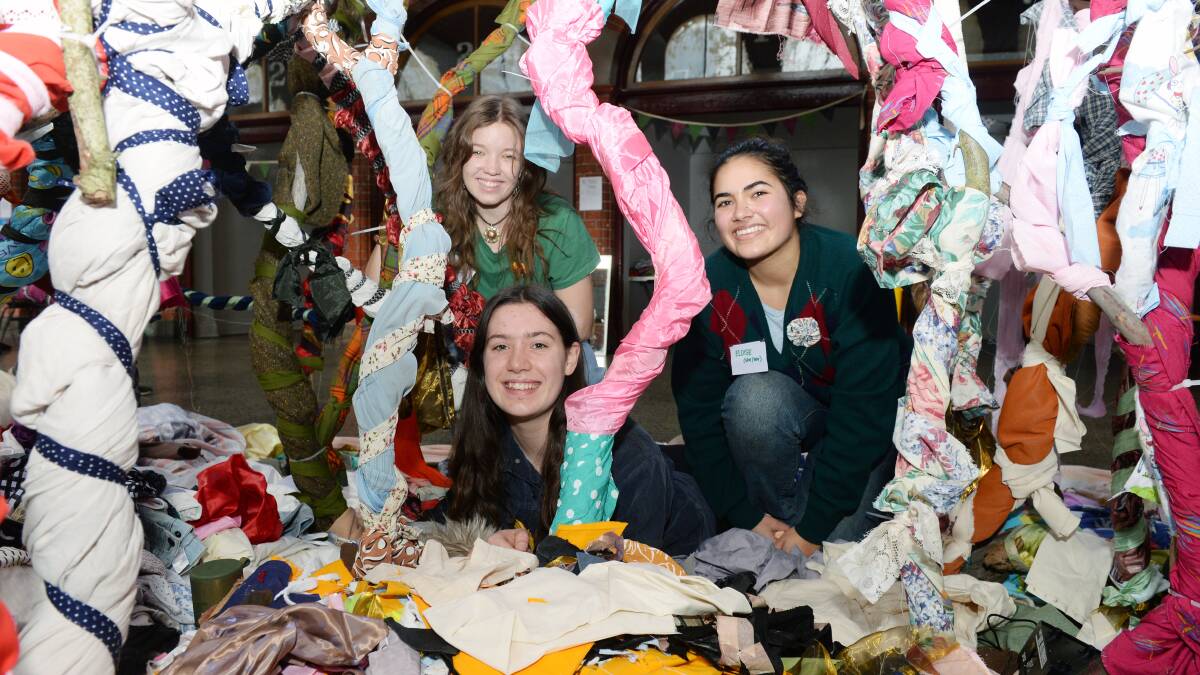 FOREST OF FABRIC: Lauren Riddel, Mikala Lund and Eloise Amirtharajah amongst the 'Fabric Forest' art installation. PHOTO: Kate Healy 