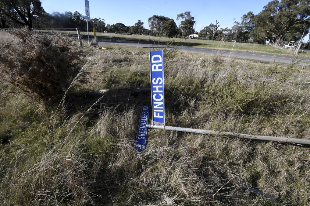 A sign knocked over in the crash on Monday afternoon. Picture: Lachlan Bence. 