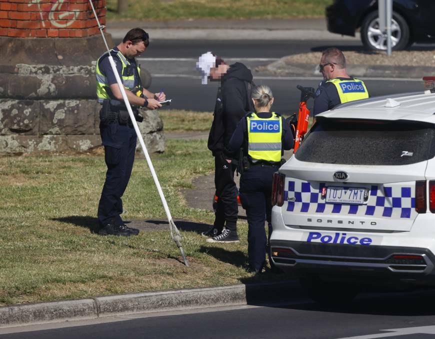 Police speak to a young man allegedly riding down Creswick Road without a helmet. Picture: Luke Hemer