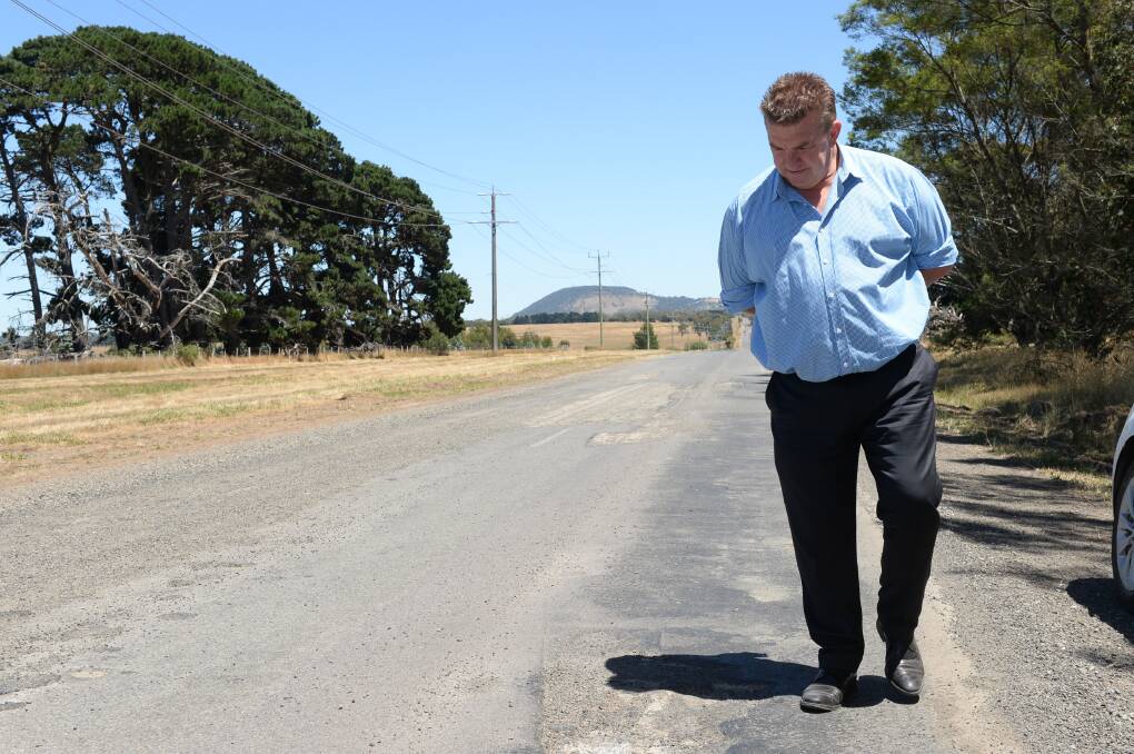 Moorabool Shire mayor Rod Ward inspecting dodgy roads on Friday. Picture by Kate Healy. 