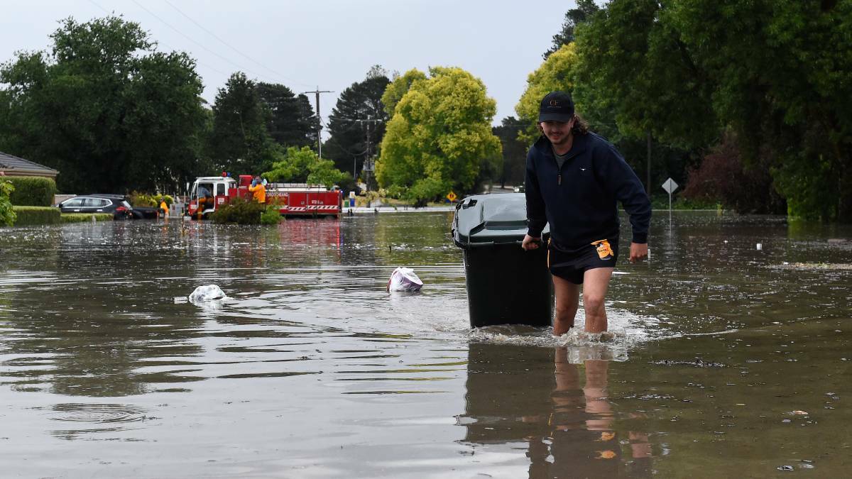 Residents deal with floodwater on Wednesday evening. Picture: Adam Trafford