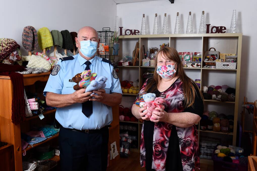 Cuddly comfort: Lieutenant Brian Webber and Jodi Passalick with some of the teddy bears. Picture: Adam Trafford. 