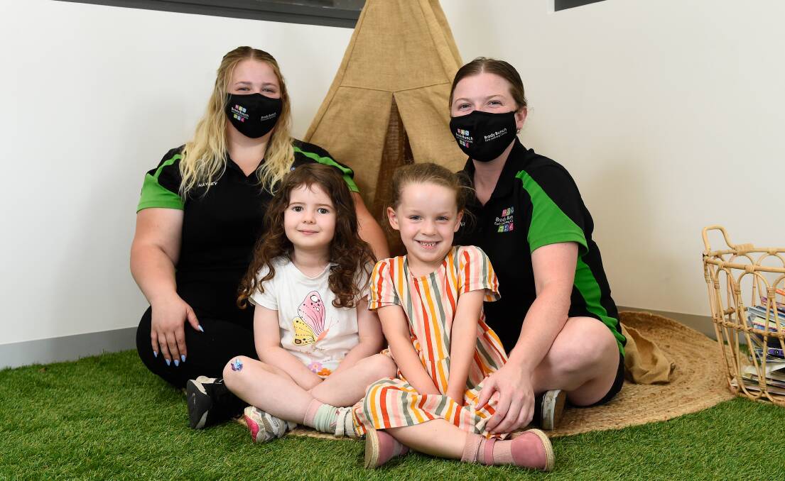 (L-R) Brady Bunch Early Learning Centre educators Hayley Haintz and Lianah Henderson with kids Ava and Zoe. Photo: Adam Trafford. 