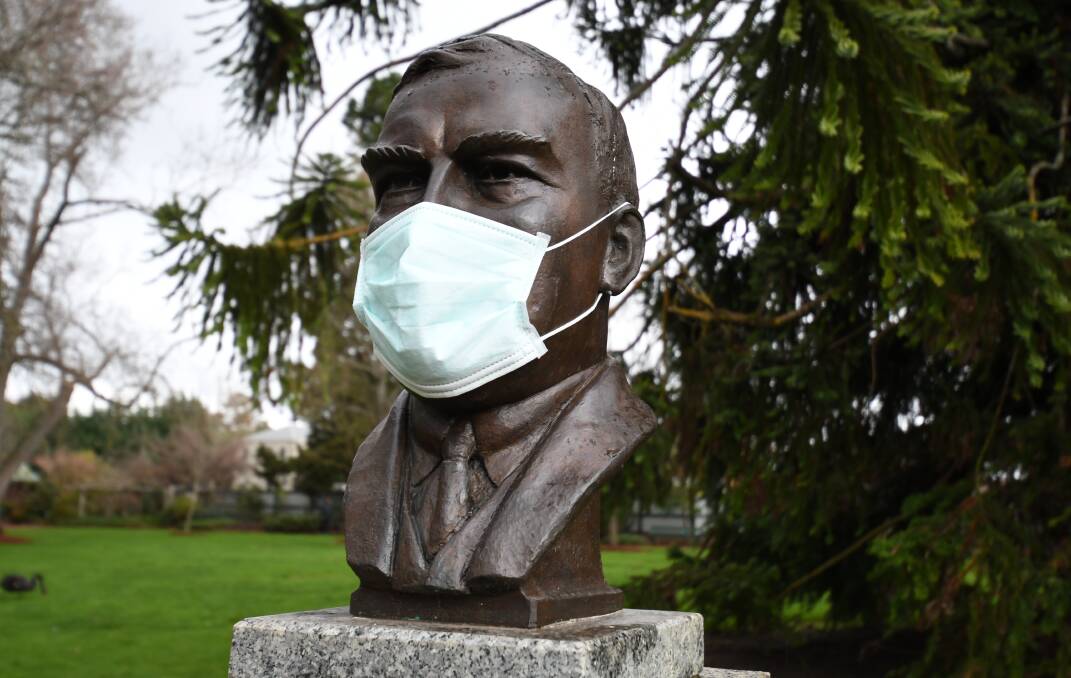 No return to pre-pandemic times: a masked head bust of Robert Menzies. Photo: Kate Healy
