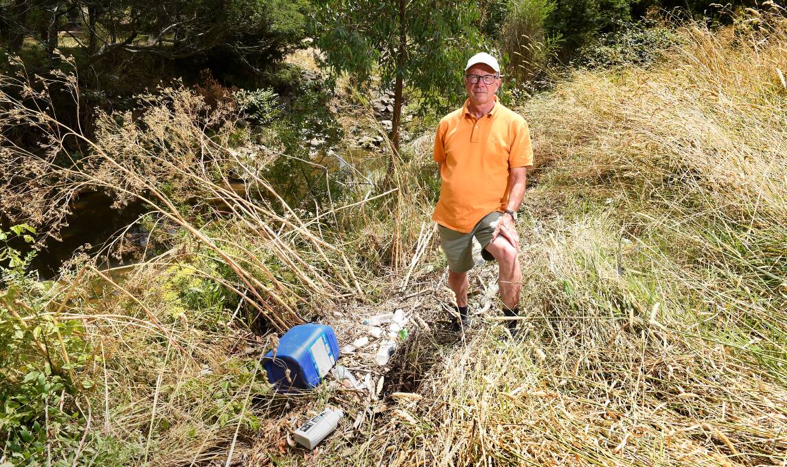 Eternal optimism: Environmentalist Col Palmer standing on the banks of the Yarrowee River last Saturday, next to washed up refuse. Photo: Adam Trafford